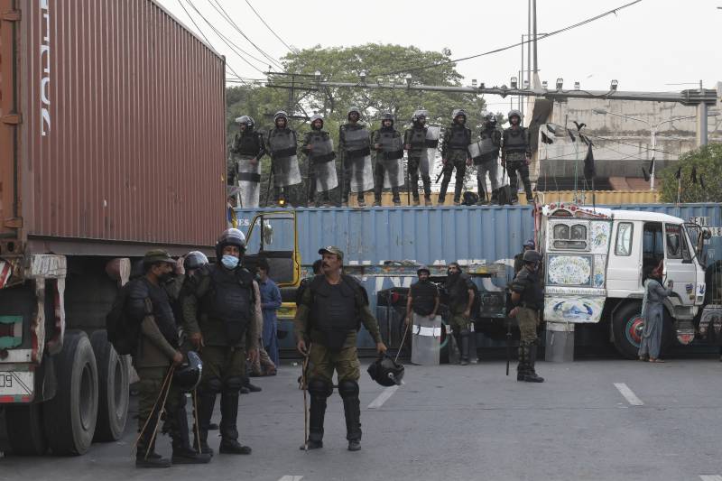 policemen beef up security by blocking roads with conta